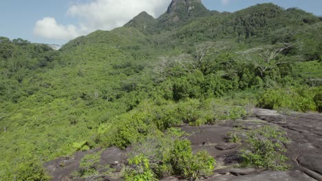Drone-shot-reveal-of-Seychelles-highest-mountain,-morn-Seychellois