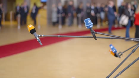 Press-people-with-microphones-waiting-for-interview-statements-during-the-European-Council-summit-in-Brussels,-Belgium