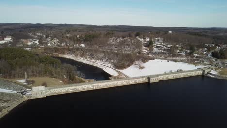Circling-wide-around-the-Wachusett-Reservoir-Dam-looking-towards-the-center-of-Clinton,-Massachusetts