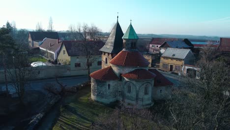Aerial-orbiting-around-the-rotunda-of-the-Nativity-of-the-Virgin-Mary-in-a-czech-village-Holubice