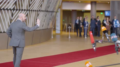 President-of-the-European-Council-Charles-Michel-waving-hand-to-press-in-the-EU-building,-goodbye---Brussels,-Belgium