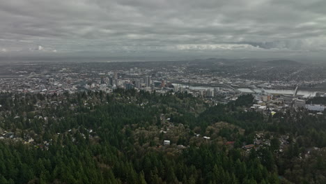Portland-Oregon-Aerial-v122-panoramic-view-flyover-Southwest-hills-wooded-neighborhood-capturing-full-downtown-cityscape-with-stormy-clouds-covering-the-sky---Shot-with-Mavic-3-Cine---August-2022