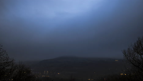 day-to-night-timelapse-of-stormy-clouds-passing-through-the-valley-of-todmorden-,-day-time-through-to-street-lamps-coming-on-,-with-a-fast-cloud-passing-through-very-dramatically