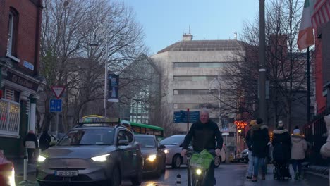 Traffic-jam-in-Dublin-with-a-senior-man-riding-a-bike-shot-handheld