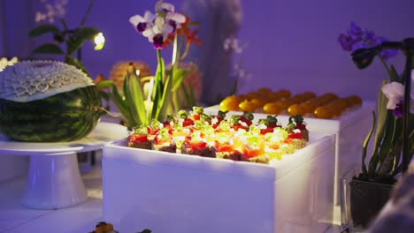 Mouthwatering-display-of-small-pastries-on-a-white-table---a-delectable-treat-for-those-with-a-sweet-tooth