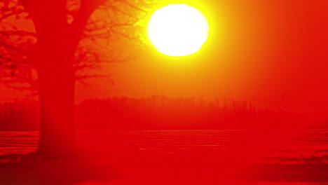 Leuchtend-Gelbe-Sonne,-Die-Vor-Einer-Rot-Erleuchteten-Himmelslandschaft-Aufgeht