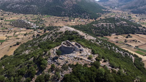 Ancient-Ruin-on-Top-of-Mountain-in-a-Hot-Climate,-Aerial-Approach
