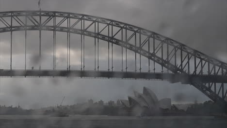 Gotas-De-Lluvia-Golpeando-El-Parabrisas-De-Un-Automóvil-Con-La-ópera-De-Sydney-Fuera-De-Foco-En-El-Fondo