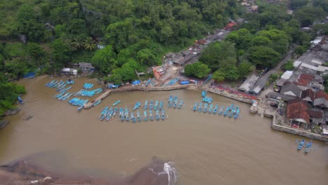 Aerial-view-of-Rows-of-blue-fishing-boats-anchored-in-the-harbour