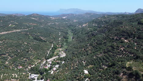 Aerial-View-Of-Mountain-Village-Of-Topolia-In-Crete,-Greece-Surrounded-By-Natural-Greenery