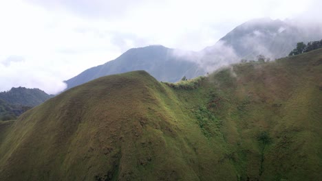 Epic-Drone-Shot-Revealing-Rainforest-Valley-Jungle-While-Flying-Through-The-Clouds-In-Rijani-Volcano-Central-Lombok,-Indonesia