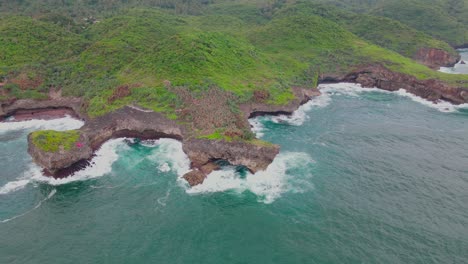 Aerial-footage-of-An-island-overgrown-with-dense-forest-with-coral-coastline