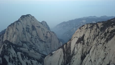 Amazing-steep-granite-cliffs-in-Huashan-mountain-range,-China-aerial