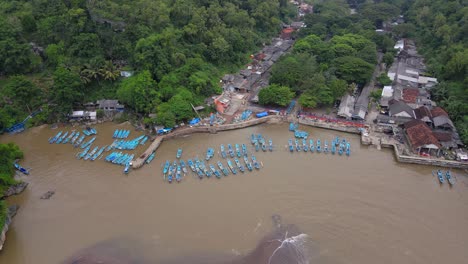Drone-shot-of-line-of-fishing-boats-anchored-in-the-harbour