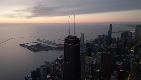 Aerial-view-around-the-John-Hancock-center,-dramatic-sunrise-in-Chicago,-USA