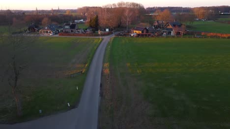 Drone-shot-of-cars-driving-down-a-country-road