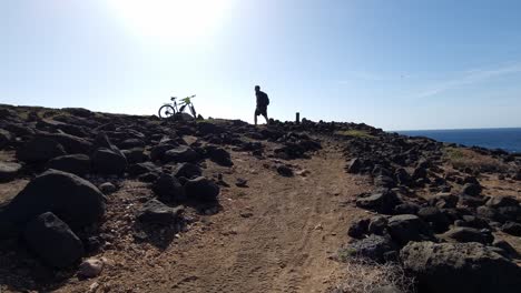 Hiking-into-sun-at-the-coast-of-Lanzarote-sea-rocks