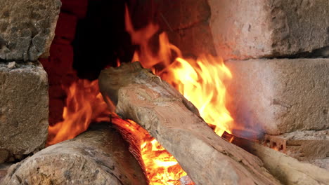 Handheld-close-up-of-blazing-wood-fed-fire-in-pottery-kiln,-Than-Ha-Vietnam