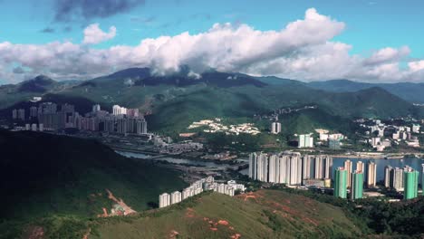 Aerial-orbit-around-Ma-On-Shan-coastal-town-of-Hong-Kong,-cloud-filled-sky
