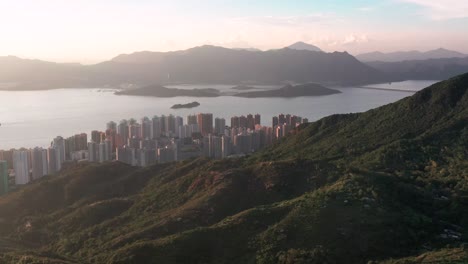 Coastal-town-of-Ma-On-Shan-Hong-Kong-aerial-reveal-under-golden-hour-light