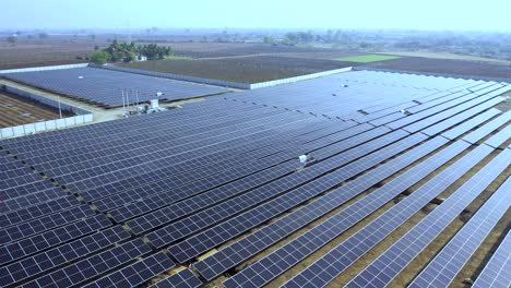 Aerial-view-of-the-electrical-power-plant-under-construction-with-a-truck-delivering-assembly-parts-for-solar-panels-on-a-frame-for-producing-electric-energy