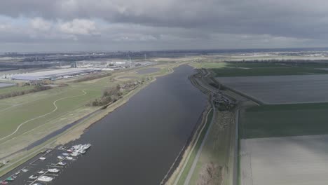 Typical-Dutch-landscape-with-harbor-on-river-and-windmills