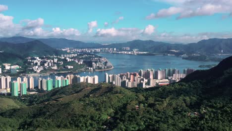 Aerial-dolly-over-Ma-On-Shan-Hong-Kong-on-bright-sunny-day,-cloudy-sky