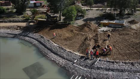 Drone-view-construction-workers-hauling-earth-in-the-construction-of-parks