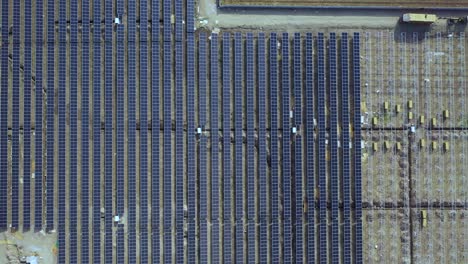 Aerial-view-of-solar-panels-installed-in-Ground,-4k,-aerial-video,-aerial-view-when-moving-top-with-moving-sideways,-slider-shoot-of-an-aerial-drone