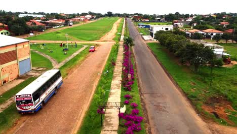 Flying-Low-Over-Beautiful-Flowers-And-Green-Grass-In-Villeta-City,-Paraguay