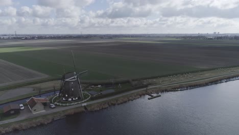 Aerial-drone-shot-of-Dutch-windmill-and-farmland