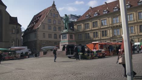 Elderly-People-at-Farmer's-Market,-Downtown-Square---Schlossplatz-In-Downtown-Stuttgart-in-4K,-Classic-Germany-Architecture,-Famous,-Red-Komodo-Cooke-Mini-S4i-Lens-Premium-Quality-|-News