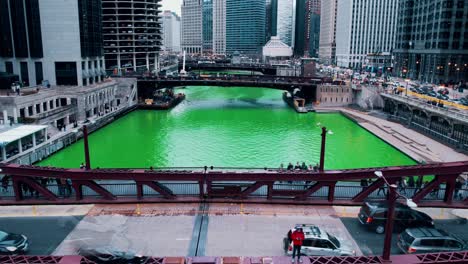 Timelapse-of-white-caucasian-male-wearing-red-jacket-on-bridge-during-Saint-Patricks-day-in-chicago