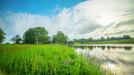 Extreme-fast-time-lapse-wide-angle-houses-on-a-small-lake-in-green-meadow