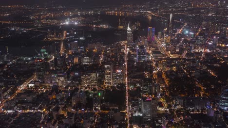 Ho-Chi-Minh-City,-Vietnam-evening-aerial-time-lapse-featuring-traffic,-key-buildings-of-skyline-and-Saigon-river-under-lights