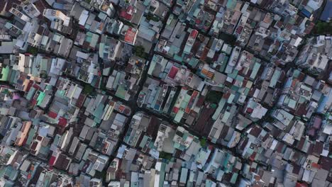 Top-down-of-high-density-urban-rooftops-in-district-four-port-area-along-the-Saigon-river-in-Ho-Chi-Minh-City,-Vietnam
