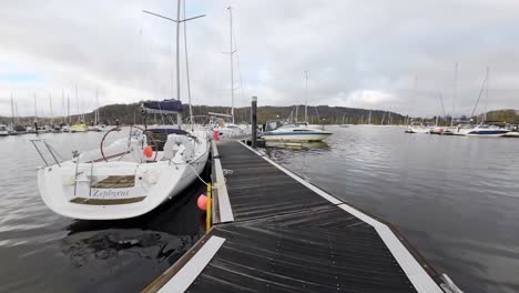 Slow-Motion-Video-Boats,-sailing-ships,-moored-on-the-harbor-of-Bowness-on-Windermere