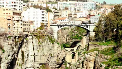 Wide-view-of-a-Constantine,-Algeria-Bridge:-This-footage-captures-the-full-scope-of-the-iconic-bridge,-showcasing-its-unique-design-and-its-place-in-Constantine's-urban-landscape