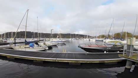 Slow-Motion-Video-Boats,-sailing-ships,-moored-on-the-harbor-of-Bowness-on-Windermere