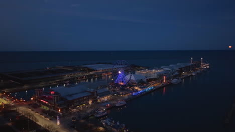 Aerial-view-around-the-Navy-Pier,-full-moon-in-Chicago,-USA---orbit,-drone-shot