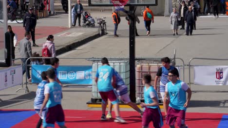 Boys-Playing-Basketball-on-Spring-Festive-Day-at-a-Square-in-Tirana:-Excitement-and-Joyful-Activity