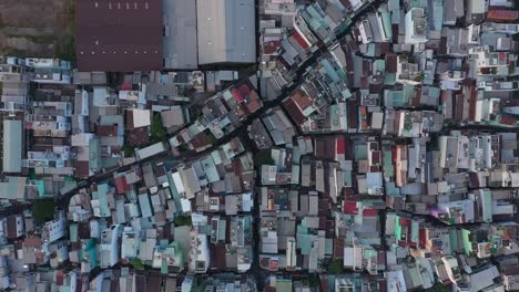 Rooftop-view-over-buildings-to-timber-waiting-to-be-exported-at-port-area-along-the-Saigon-river-in-Ho-Chi-Minh-City,-Vietnam