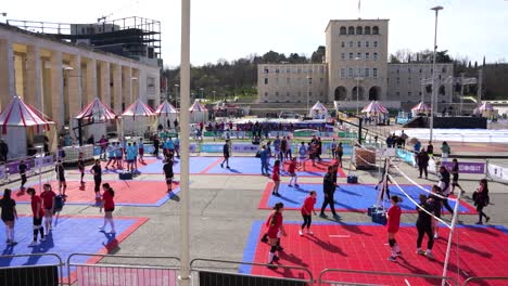 Boys-and-Girls-Playing-Basketball,-Volleyball-and-other-games-on-a-Festive-Day-at-a-Square-in-Tirana:-Excitement-and-Joyful-Activity