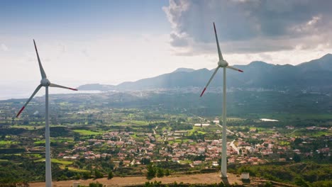 Wind-power-generators-among-Turkish-landscape-of-valley-with-villages-and-Mediterranean-sea,-Reşadiye-peninsula,-Muğla-province,-Kızlan-village,-Datça-city