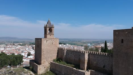 Flying-over-a-Moorish-castle-in-a-town-in-Malaga,-Andalusia