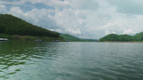4K-Cinematic-landscape-nature-panoramic-footage-of-the-Mae-Kuang-Dam-Lake-at-Doi-Saket,-Northern-Thailand-on-a-sunny-day-while-sailing-on-a-moving-boat,-close-to-the-water