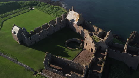 aerial-view-downwards-on-the-castle-of-dunnottar-showing-details-of-the-build-and-the-gardens