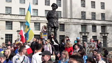 Proukrainische-Anhänger-Mit-Fahnen-Und-Transparenten-Stehen-Vor-Einer-Statue-Von-Field-Marshall-Viscount-Alanbrooke,-Um-In-Whitehall-Gegen-Die-Russische-Invasion-In-Der-Ukraine-Zu-Protestieren