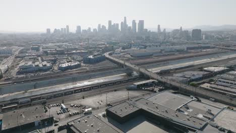 Aerial-Drone-Shot-Over-Downtown-Los-Angeles-Skyline-and-Boyle-Heights-Industrial-Area