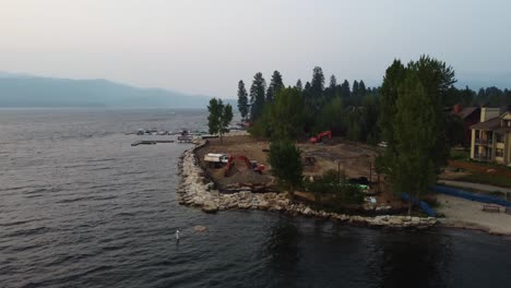 Clockwise-drone-shot-of-construction-on-the-shore-of-Payette-Lake-during-sunset